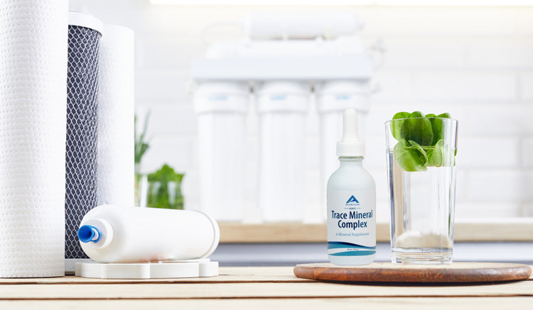 Glass of remineralized RO water with trace mineral drops